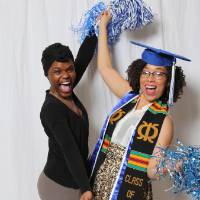 Two graduate pose at Gradfest